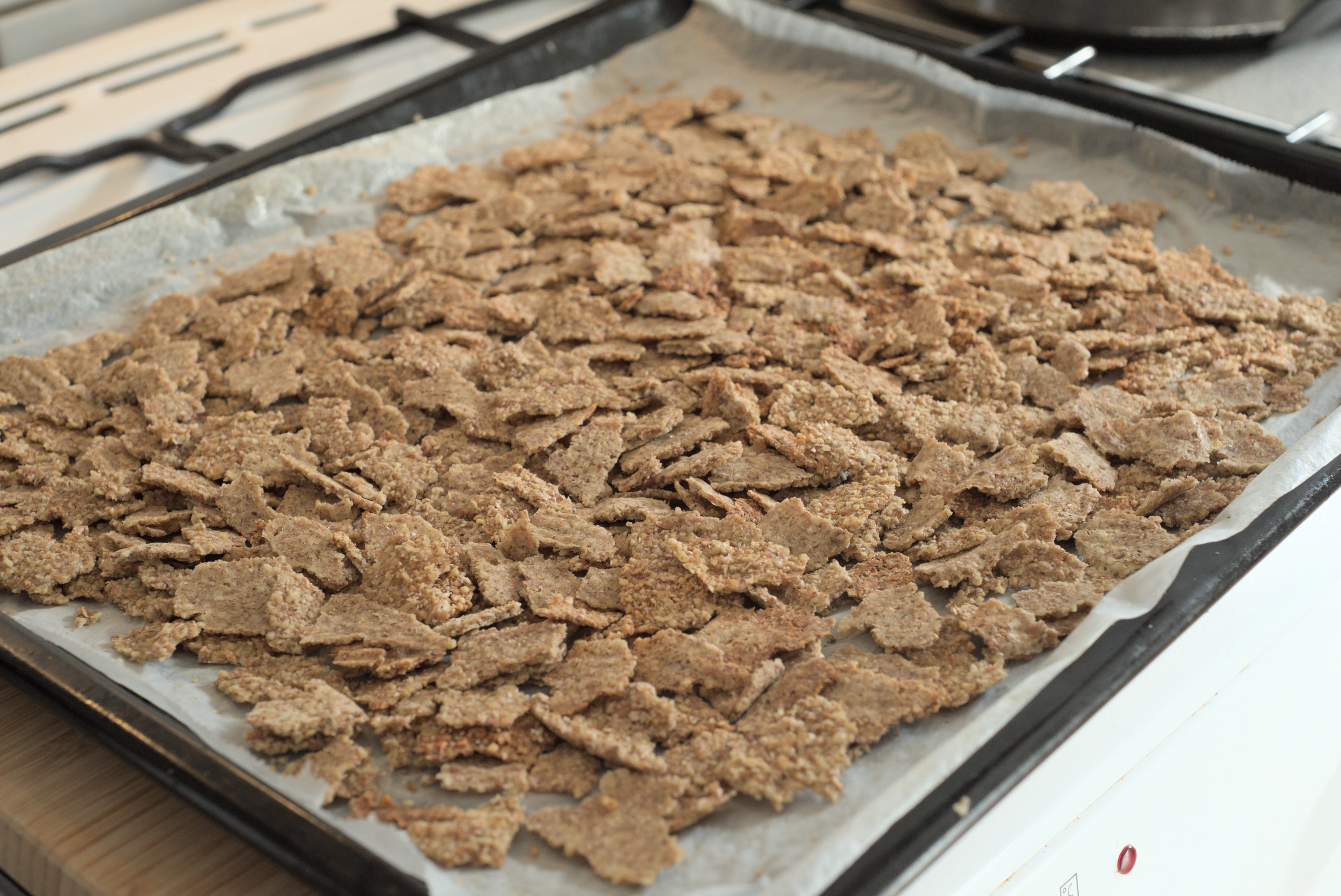 Homemade bran flakes on a baking tray